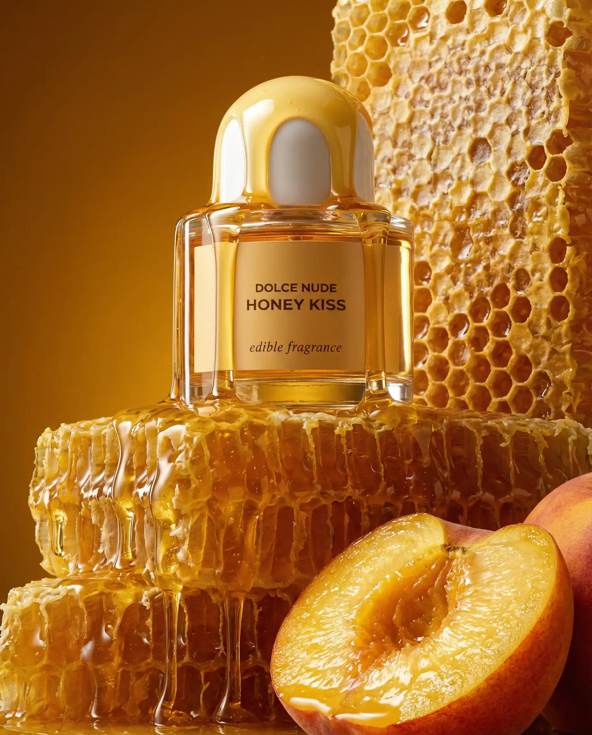 DOLCE NUDE Honey Kiss edible fragrance bottle surrounded by golden honeycomb texture, honey drips, and fresh peach slices