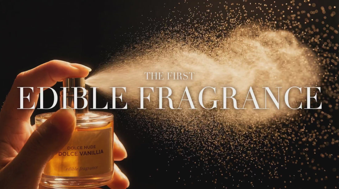 DOLCE NUDE Vanillia Dolce edible fragrance bottle held in hand with golden sparkle particles floating on dark background, text reads the first edible fragrance
